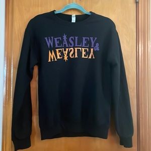Harry Potter navy pullover with purple and gold WEASLEY mirrored lettering